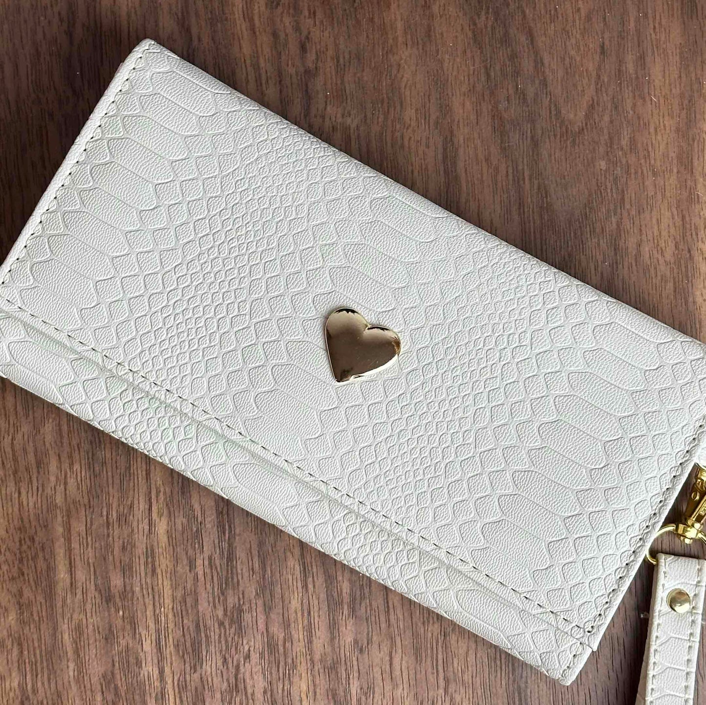 CARTERA MUÑEQUERA HUESO