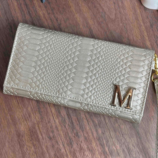 CARTERA MUÑEQUERA DORADA