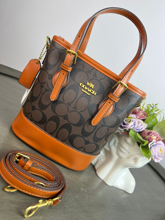 CROSSBODY COACH ESTILO CUBETA MARRON/NEGRO
