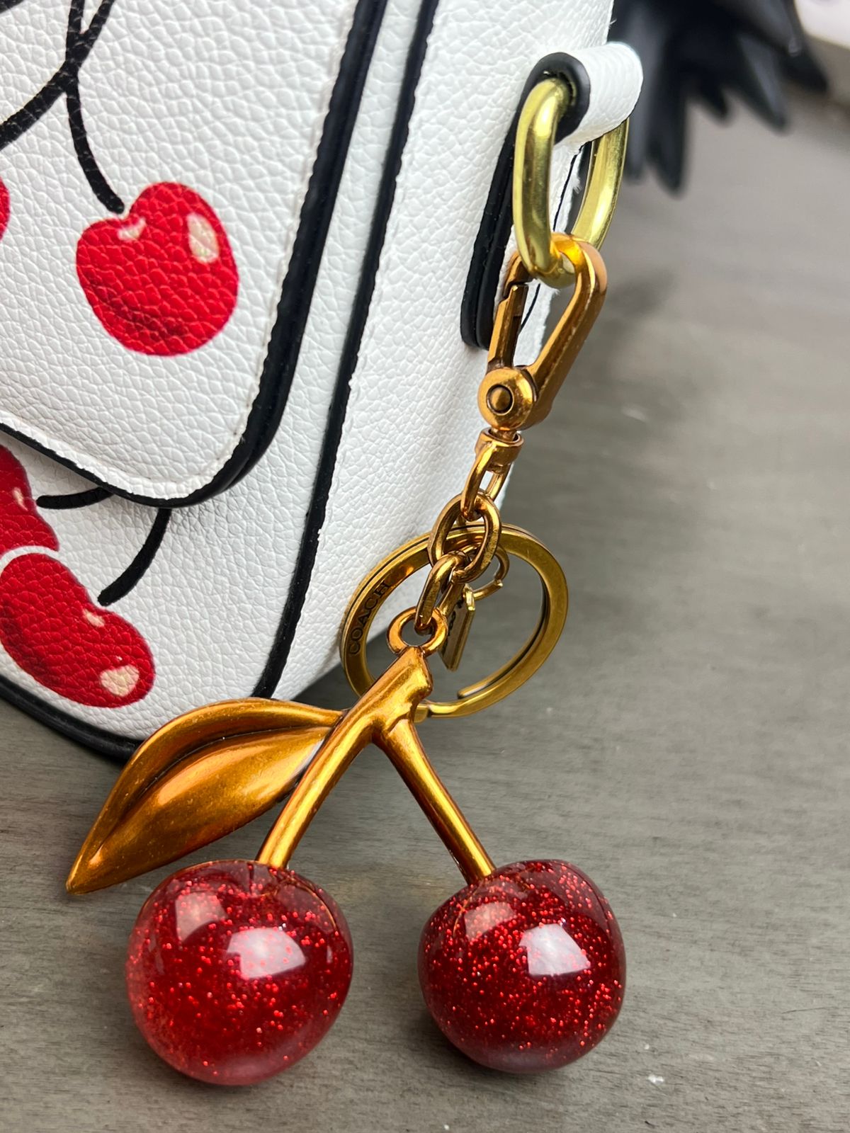 CROSSBODY COACH LLAVERO CEREZA/ CAFE ESTAMPADO